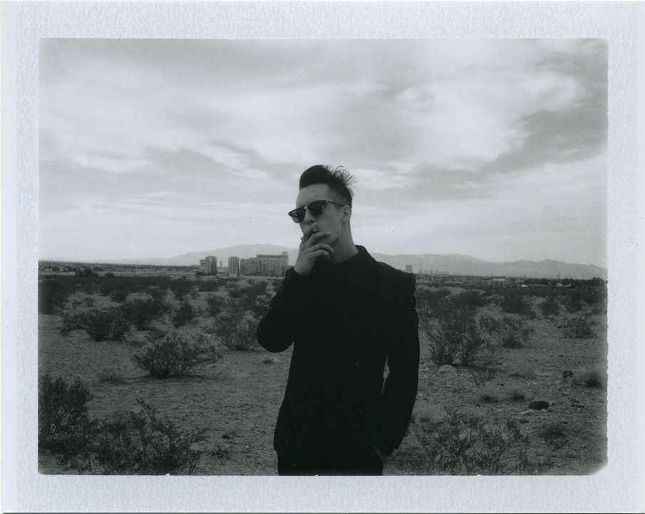 Brendon Urie smoking a cigarette in 2013, standing alone as Panic! at the Disco's sole survivor