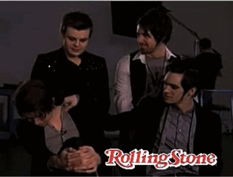 Brendon Urie rubbing Ryan Ross' shoulder during Panic at the Disco's Rolling Stone interview